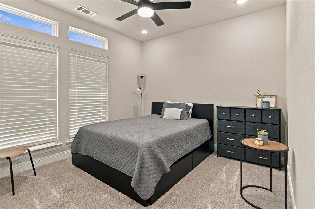 4822 Wichita Street, Granbury, TX 76048 Recessed lighting, ceiling fan, high ceilings, large windows with blinds, and carpeted flooring