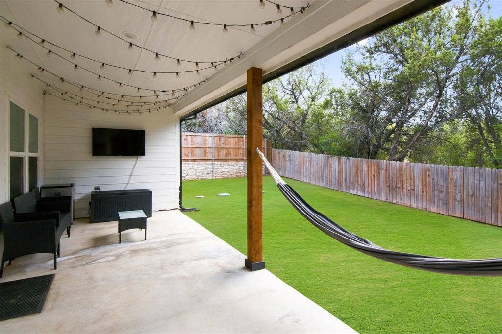 4822 Wichita Street, Granbury, TX 76048 Covered patio featuring a wood support column and string lighting