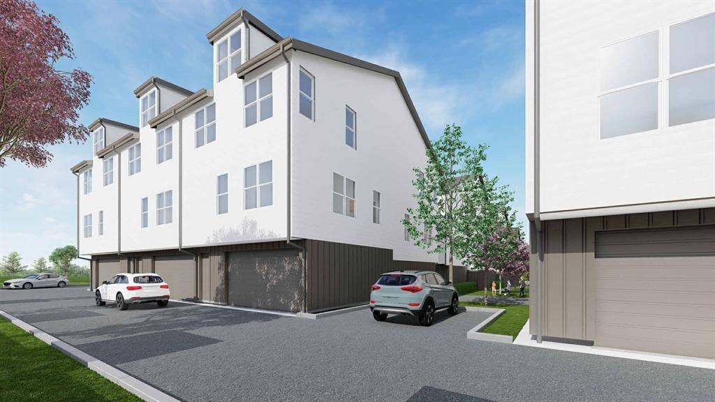7515 Chaucer Place, Dallas, TX 75237 Modern townhomes featuring a multi-story design, white exterior cladding, individual garage entrances, dormer windows, and a paved driveway