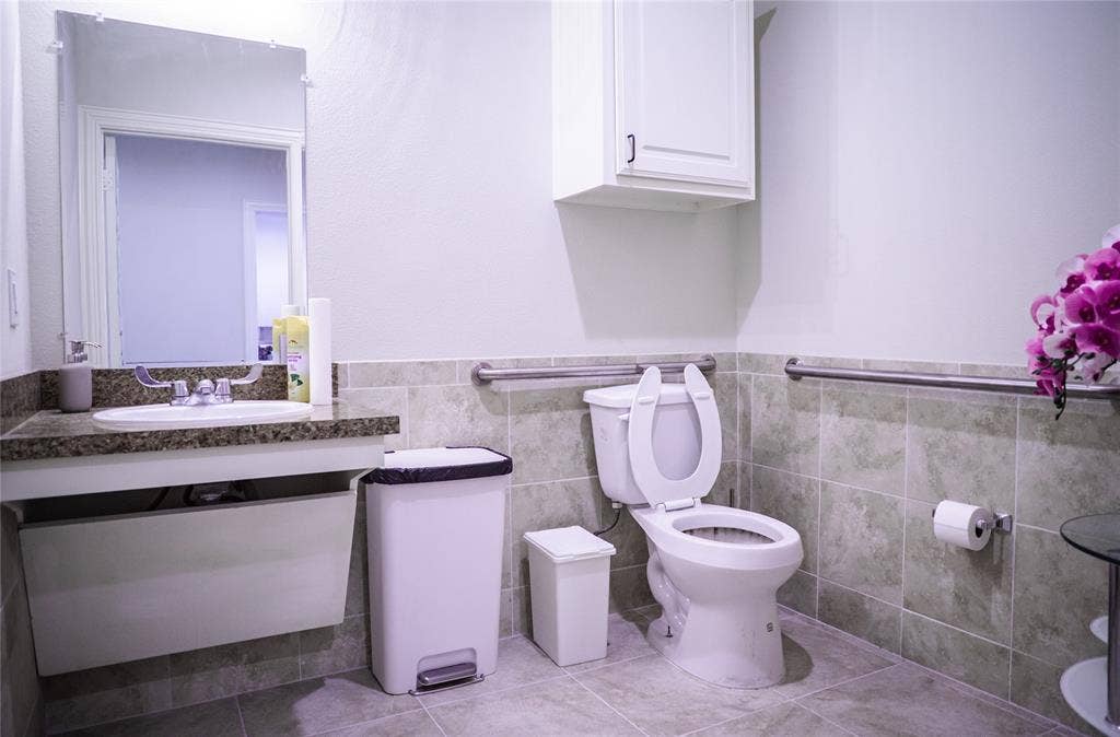 8668 John Hickman Parkway, #906, Frisco, TX 75034 Vanity with a granite-style countertop, undermount sink, and wall-mounted mirror