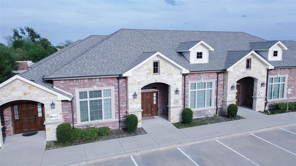 8668 John Hickman Parkway, #906, Frisco, TX 75034 Elegant brick and stone facade featuring multiple gabled rooflines with dimensional shingle detailing