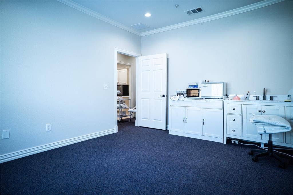 8668 John Hickman Parkway, #906, Frisco, TX 75034 Recessed lighting, crown molding, white trim, white paneled doors, and built-in white cabinetry with a sink