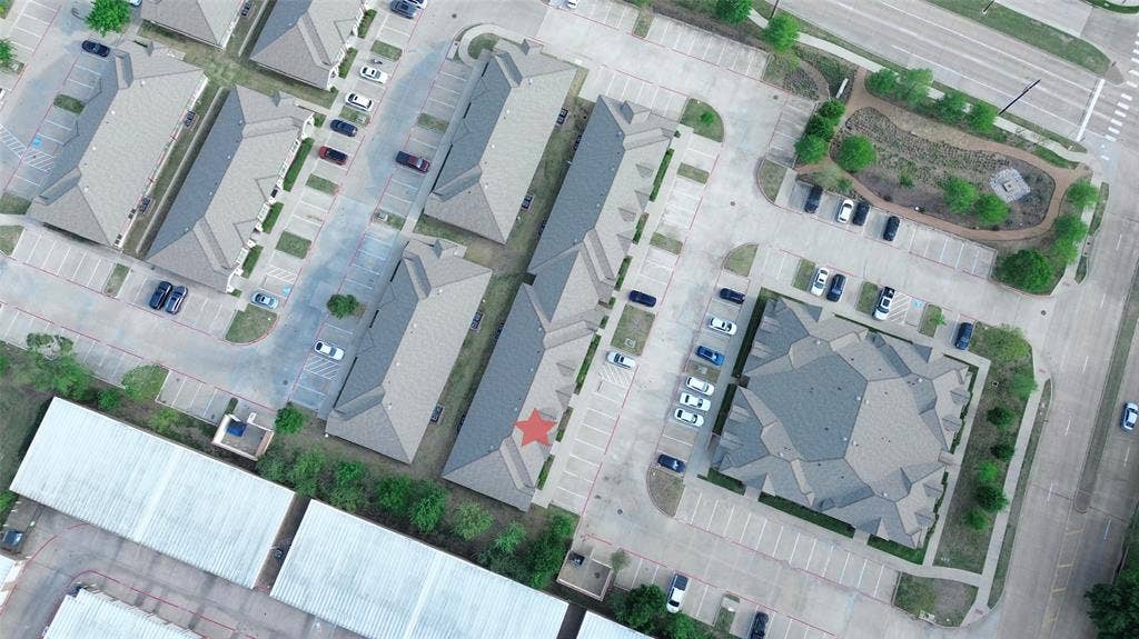 8668 John Hickman Parkway, #906, Frisco, TX 75034 Multiple residential buildings with gabled roofs, extensive surface parking areas, paved roadways, and integrated green spaces