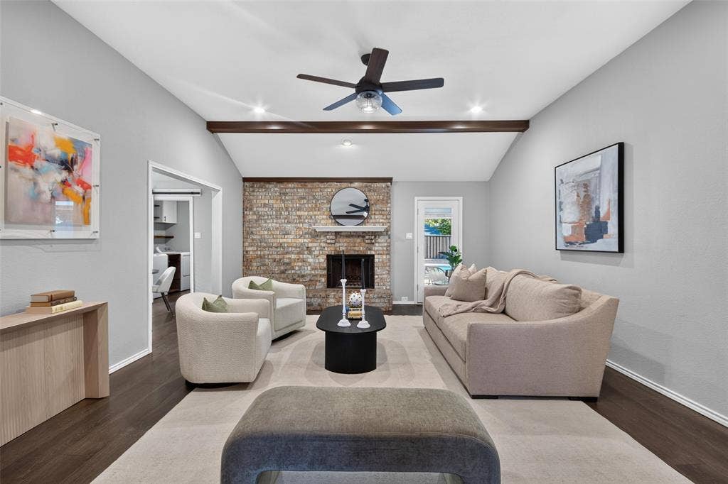 Vaulted ceiling with exposed wood beams and recessed lighting
