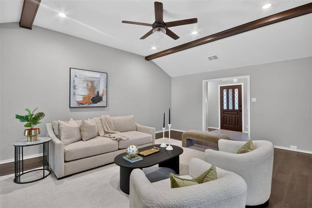 Vaulted ceiling with exposed wood beams, recessed lighting, and a ceiling fan