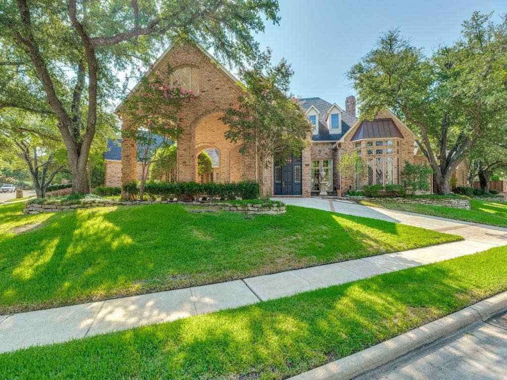 Brick exterior with a prominent arched entry and a turretted window feature