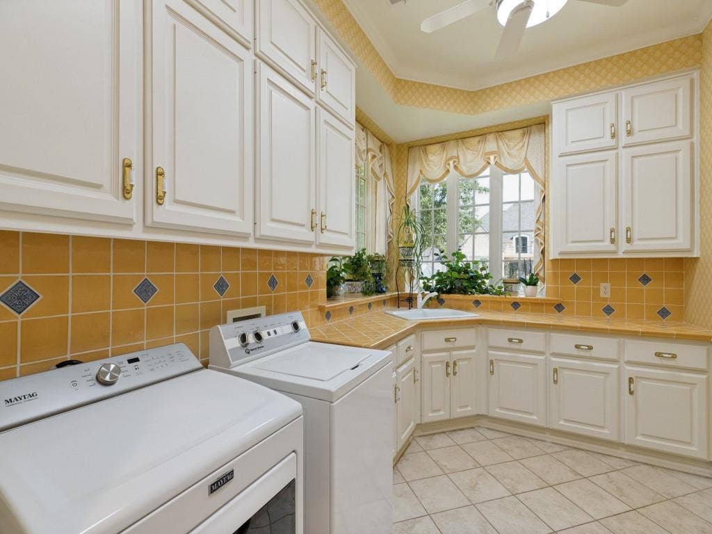 White cabinetry with gold-tone hardware, a tiled countertop, and a tiled backsplash with diamond accents