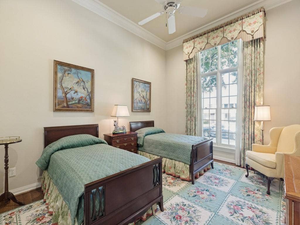 High ceilings with crown molding, double casement window, ceiling fan, and wood-finish flooring