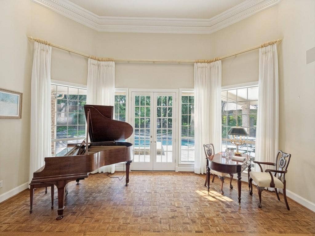 Bay windows with exterior views, French doors, hardwood parquet flooring, and decorative crown molding