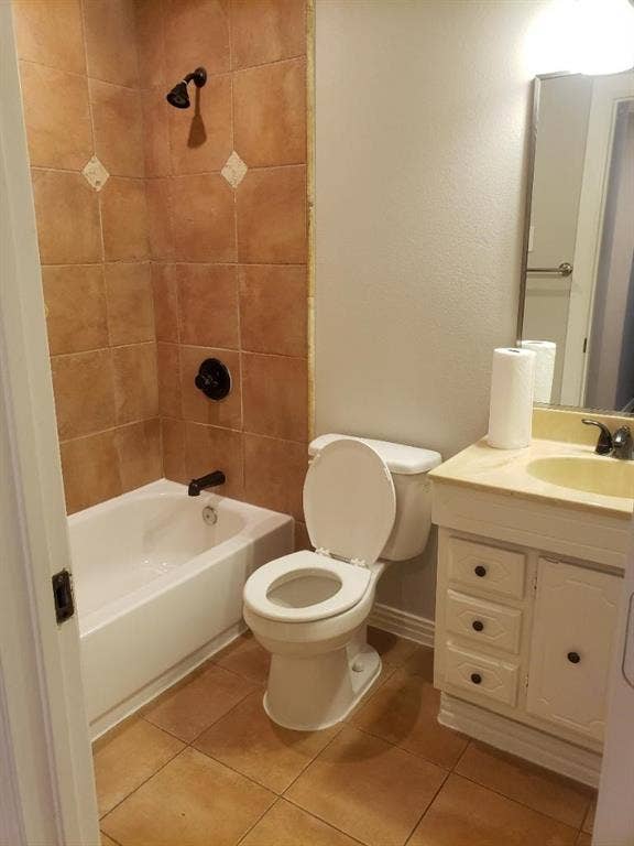 3602 Palm Drive, Mesquite, TX 75150 Bathroom featuring a tile-surround shower with dark bronze fixtures, a white bathtub, a toilet, and a vanity with an integrated sink