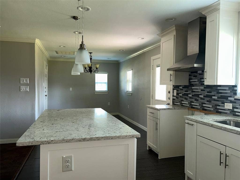 3602 Palm Drive, Mesquite, TX 75150 Kitchen featuring white cabinetry, stone countertops, dark wood-finish flooring, a mosaic tile backsplash, and stainless steel range hood