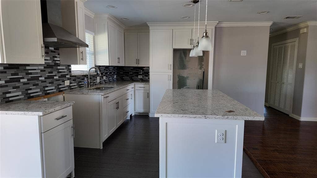 3602 Palm Drive, Mesquite, TX 75150 Kitchen featuring white cabinetry, light-toned countertops, a mosaic tile backsplash, a stainless steel range hood, and dark wood-finish flooring