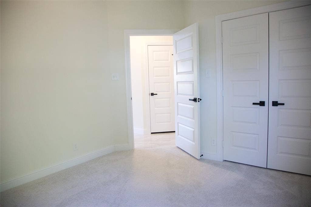 9432 PRAIRIEVIEW Drive, Crowley, TX 76134 Light-toned walls, light-toned carpet flooring, white paneled doors with matte black hardware