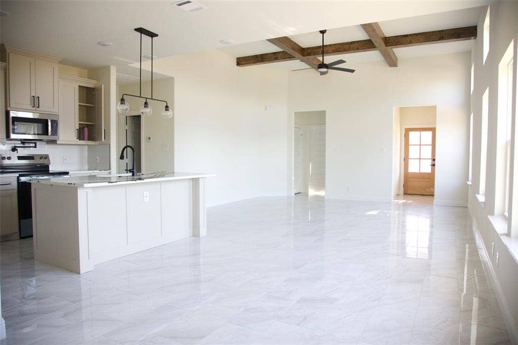 9432 PRAIRIEVIEW Drive, Crowley, TX 76134 Open-concept living space with high ceilings, exposed wood beams, and large windows