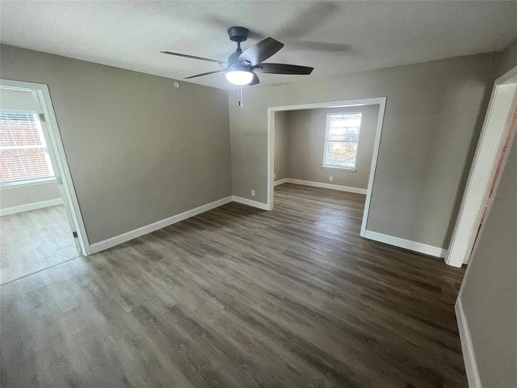 622 Austin Street, Grand Prairie, TX 75051 Interior space featuring wood-finish flooring, neutral wall paint, and a ceiling-mounted fan with integrated lighting