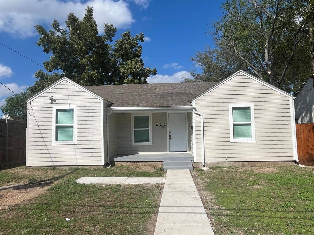 622 Austin Street, Grand Prairie, TX 75051 Single-story exterior featuring light-toned horizontal siding, double-gable roofline, recessed front entry, and concrete walkway