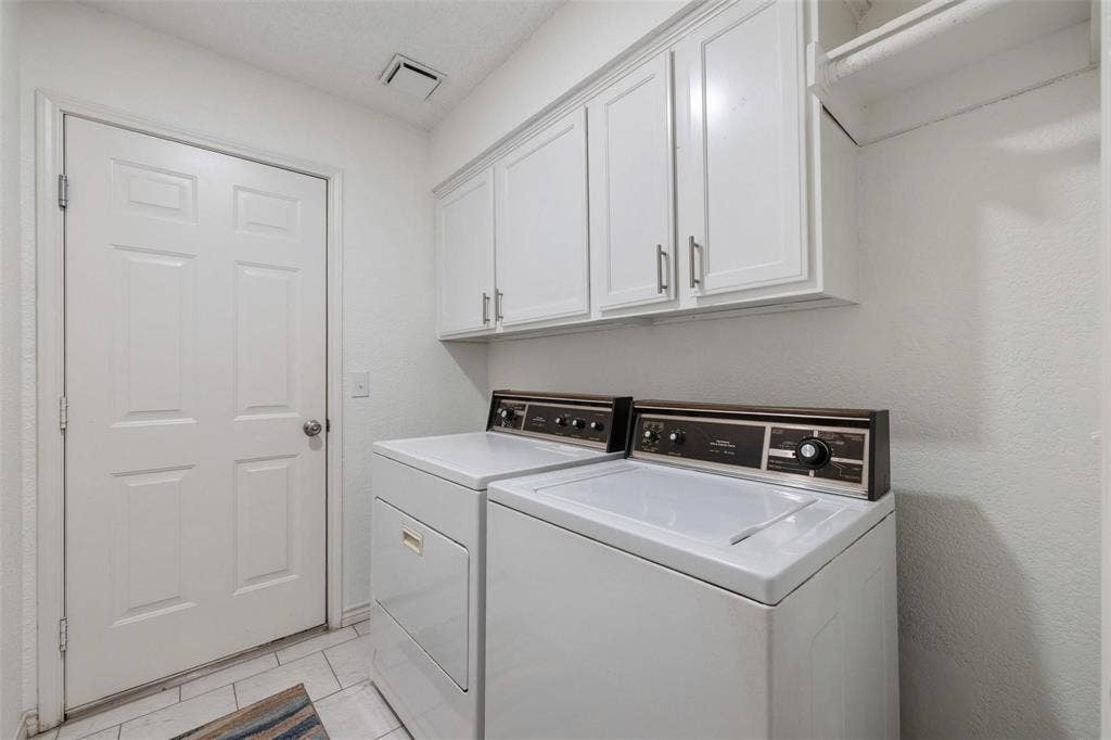 521 Palm Desert Drive, Garland, TX 75044 White shaker-style cabinetry with brushed nickel hardware