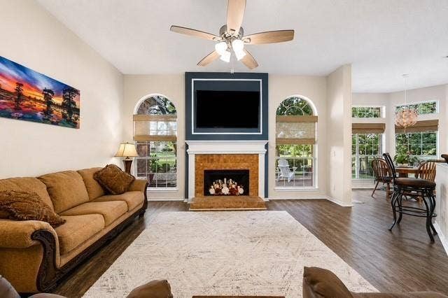 521 Palm Desert Drive, Garland, TX 75044 Spacious great room featuring hardwood flooring, a gas fireplace with wood-finish surround, and a wall-mounted flat-screen television