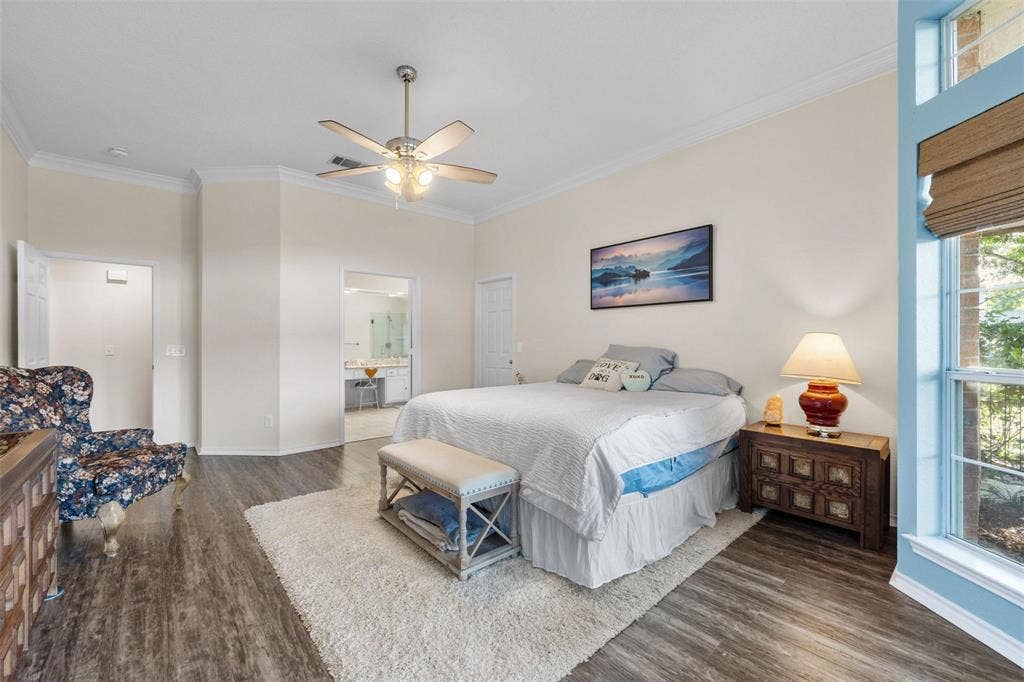 521 Palm Desert Drive, Garland, TX 75044 Wood-finish flooring, ceiling fan with integrated lighting, crown molding, and large window with natural light