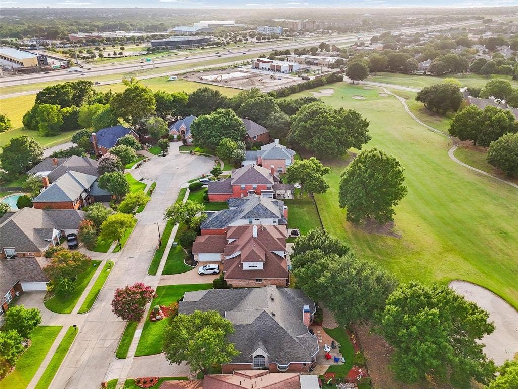 521 Palm Desert Drive, Garland, TX 75044 Residential area featuring multiple homes with varied rooflines and brick exteriors