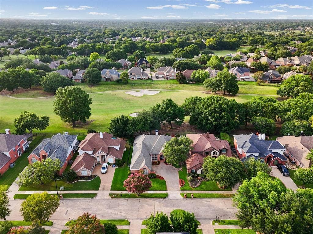 521 Palm Desert Drive, Garland, TX 75044 Residential street with manicured lawns, mature trees, and a golf course backing the properties