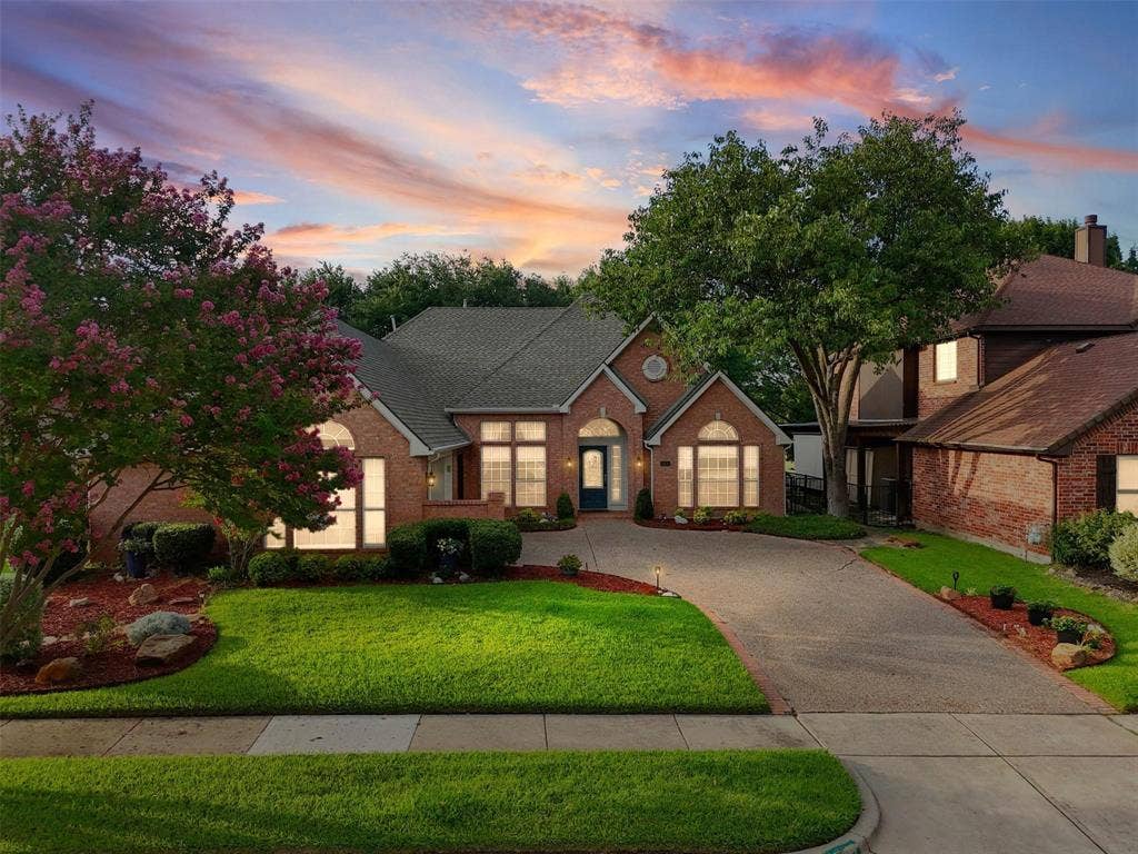 521 Palm Desert Drive, Garland, TX 75044 Brick exterior with a gabled roof and arched entryways