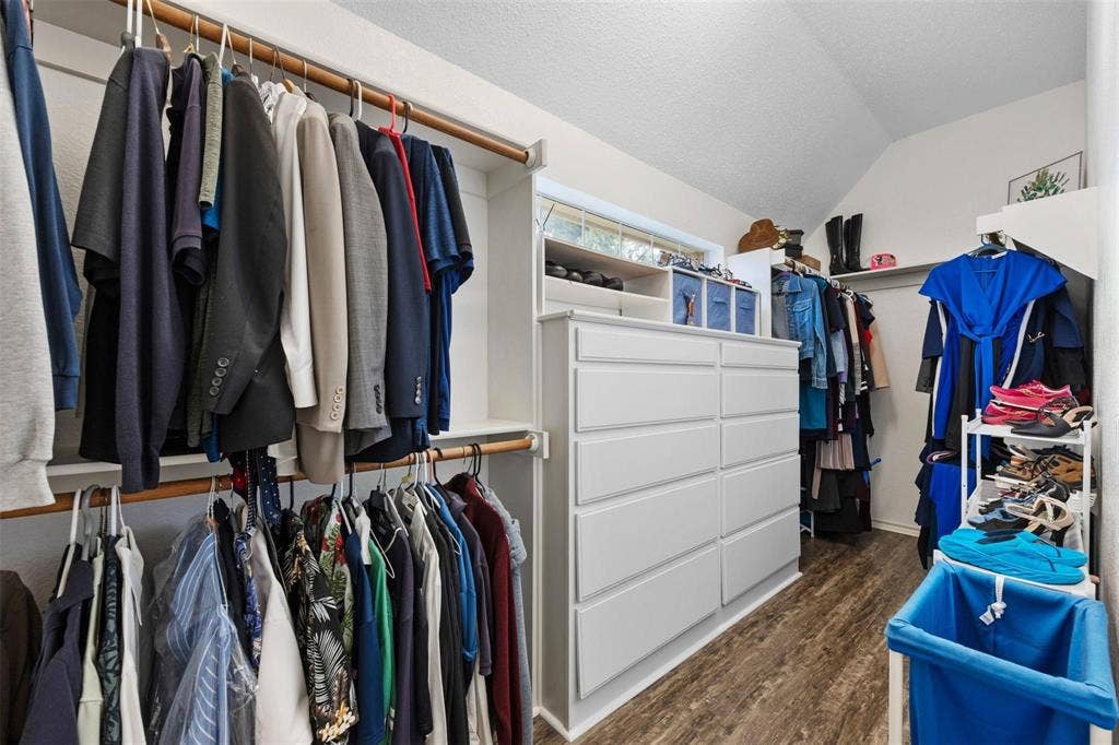521 Palm Desert Drive, Garland, TX 75044 Walk-in closet featuring wood-finish flooring, built-in shelving, and a multi-drawer dresser