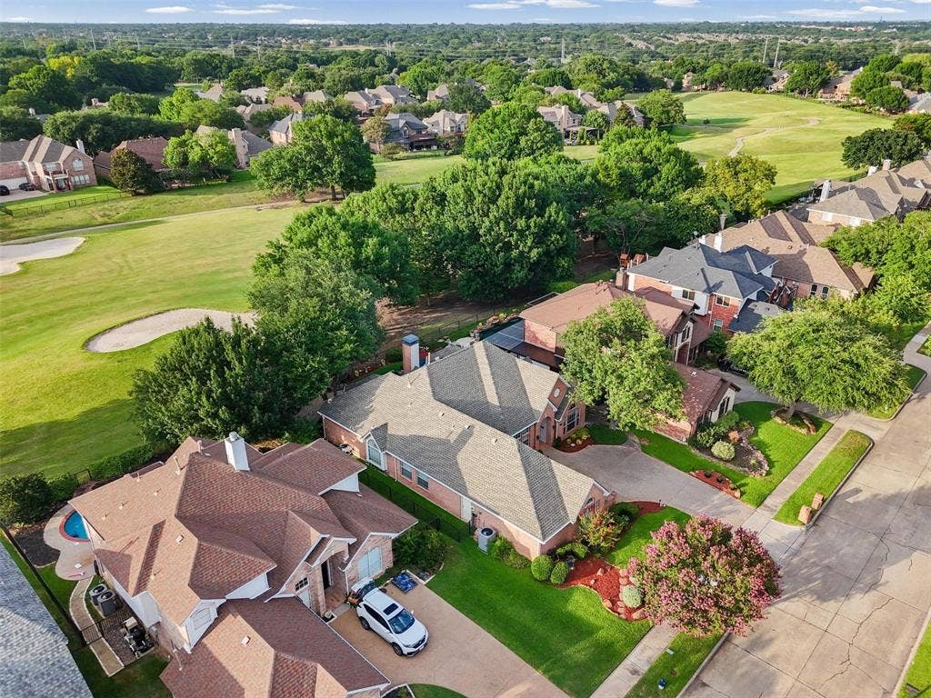 521 Palm Desert Drive, Garland, TX 75044 Aerial perspective showcasing a residential neighborhood with a golf course backdrop