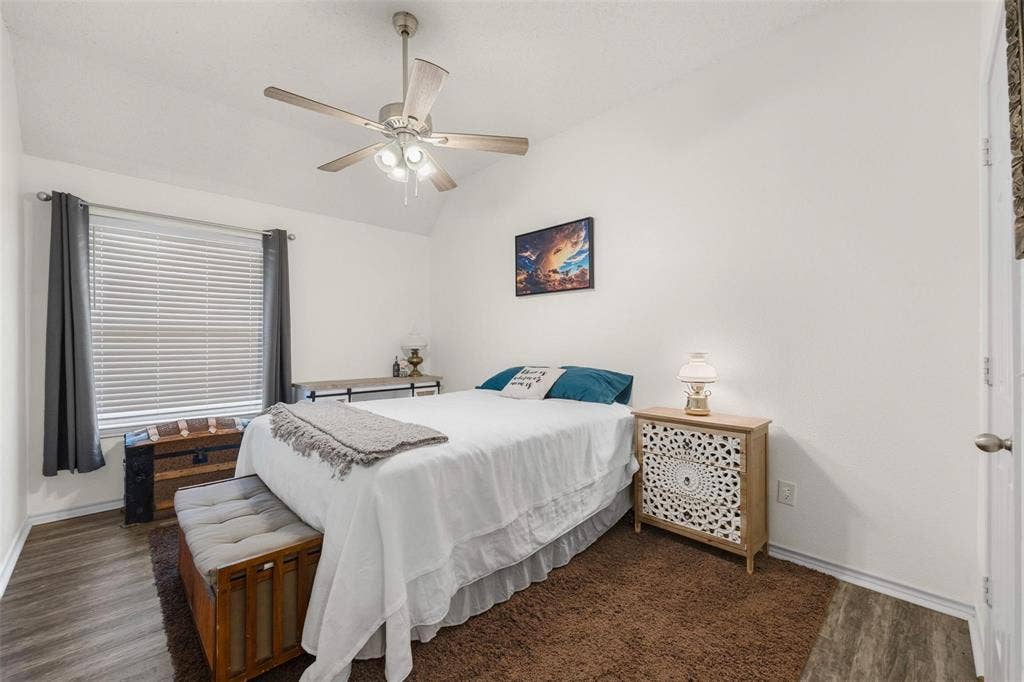 521 Palm Desert Drive, Garland, TX 75044 Vaulted ceiling with a ceiling fan, wood-finish flooring, and white walls