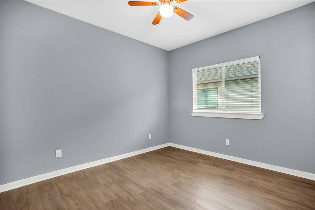 440 Pecan Hollow, Garrett, TX 75119 Room featuring wood-finish flooring, a ceiling fan with integrated lighting, and a window with white blinds