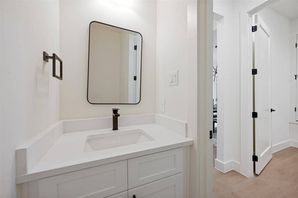 1511 Morrell Avenue, Dallas, TX 75203 White vanity with shaker-style cabinetry, an integrated sink, and a matte black single-handle faucet