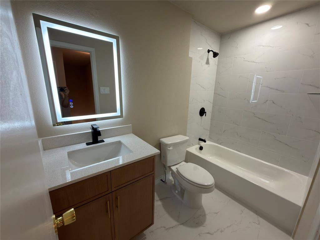 1834 Caldwell, Garland, TX 75041 Bathroom featuring a wood-finish vanity with a light-colored countertop, integrated sink, and matte black faucet