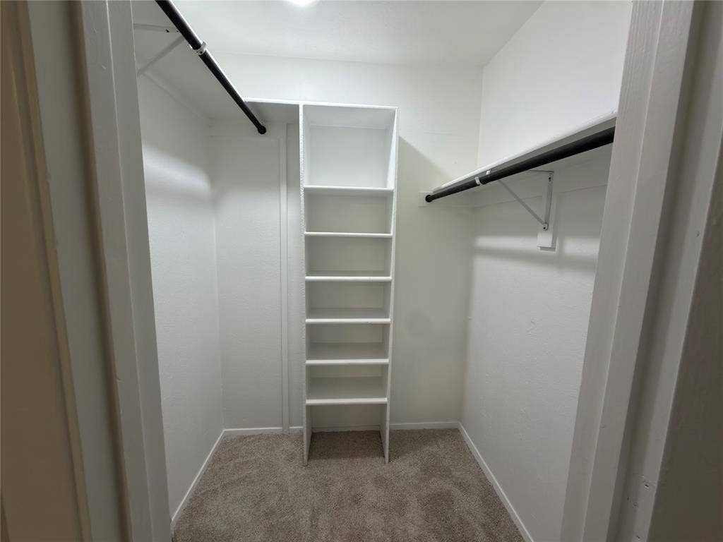 1834 Caldwell, Garland, TX 75041 Walk-in closet with carpet flooring, built-in shelving, and dual hanging rods