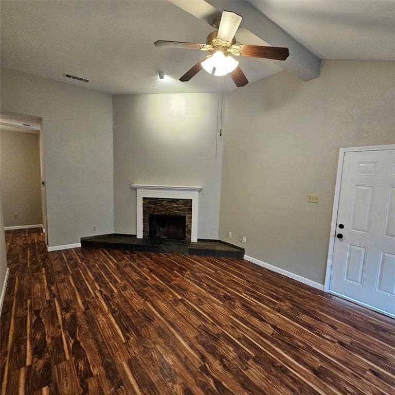 9600 ROYAL, #612, Dallas, TX 75243 Unfurnished living room with wood finished floors, a ceiling fan, and a stone fireplace
