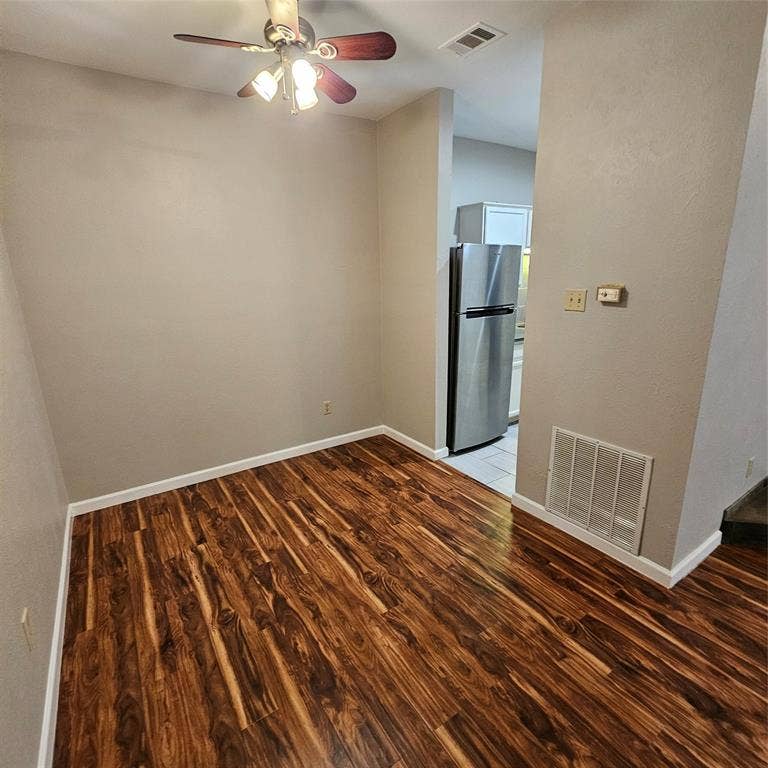 9600 ROYAL, #612, Dallas, TX 75243 Spare room featuring light wood finished floors and a ceiling fan