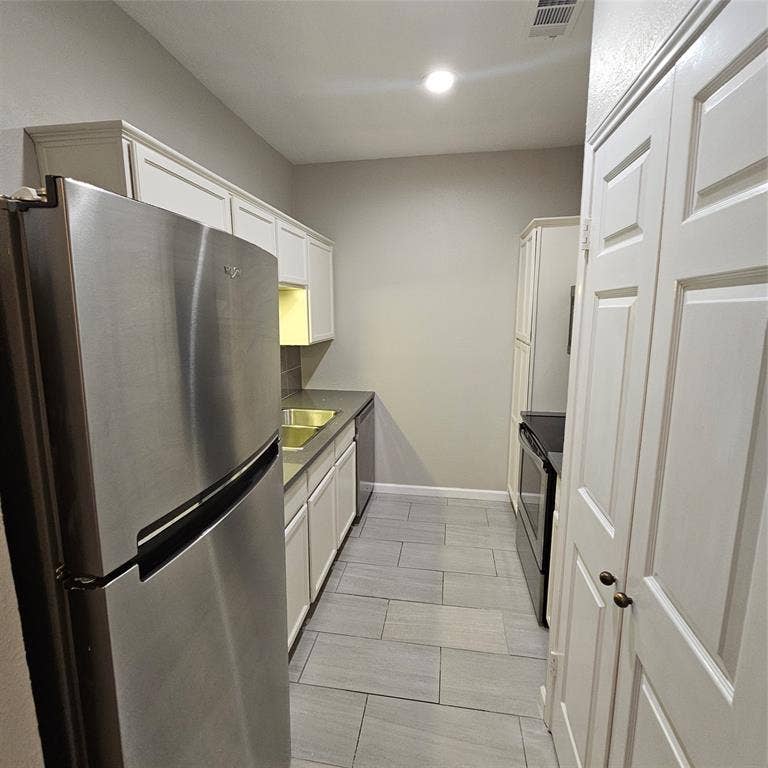 9600 ROYAL, #612, Dallas, TX 75243 Kitchen with fridge, stove, white cabinetry, dishwashing machine, and recessed lighting