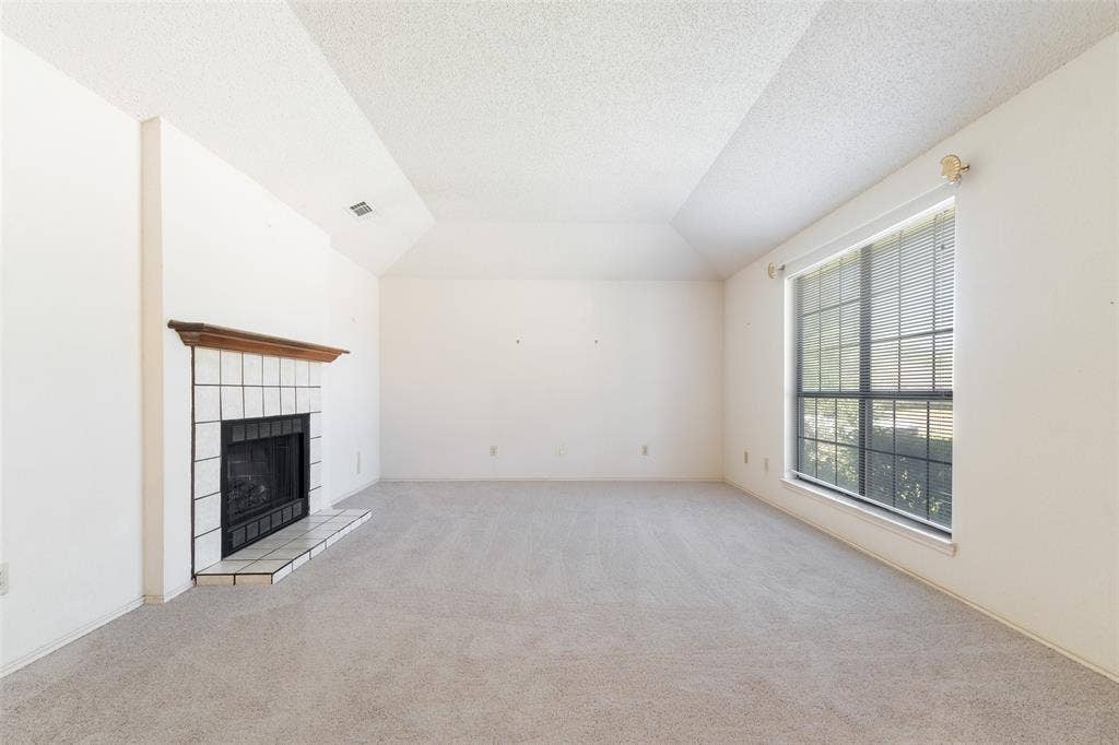 1002 Courtney Drive, Mesquite, TX 75150 A very spacious living room with a wood burning fireplace.