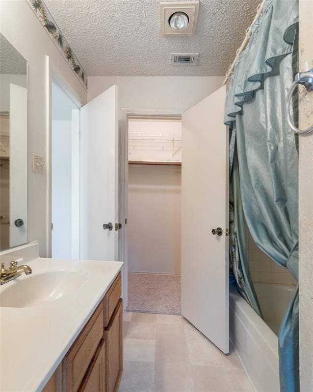 1002 Courtney Drive, Mesquite, TX 75150 A walk-in closet is at the far end of the owners bathroom.
