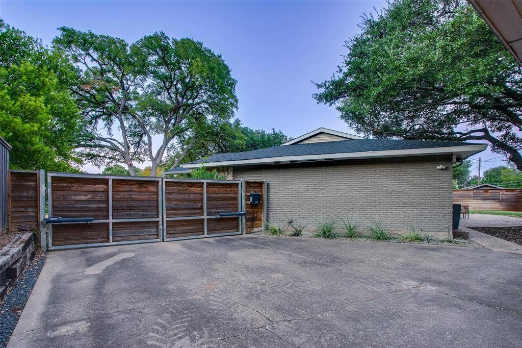 3918 Royal Palms Court, Dallas, TX 75244 Motorized driveway gate adds privacy to the rear parking and backyard.
