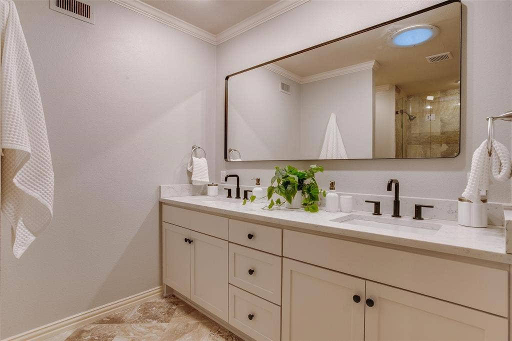 3918 Royal Palms Court, Dallas, TX 75244 Renovated Primary Bath with long dual-sink vanity and generous storage.