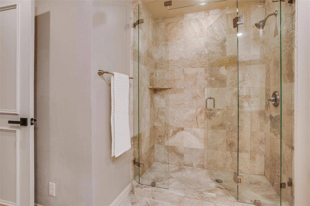 3918 Royal Palms Court, Dallas, TX 75244 Primary Bath features an oversized glass-enclosed stone shower.