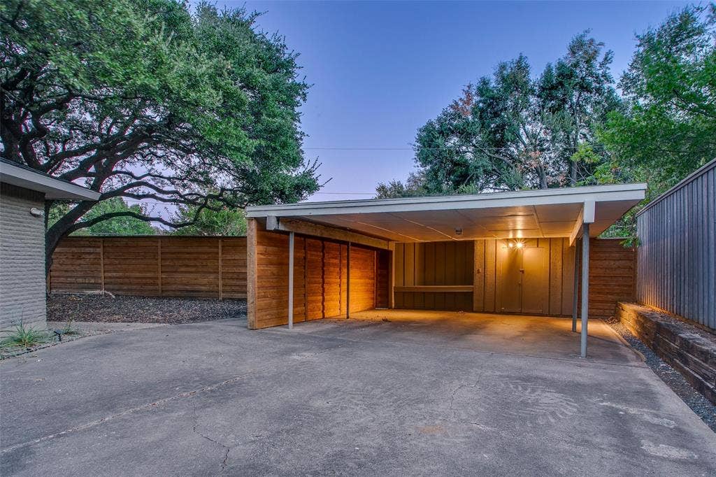 3918 Royal Palms Court, Dallas, TX 75244 Covered parking tucked privately behind the gated driveway. Note the additional storage, and existing power supply that could be upgraded for EV charging.