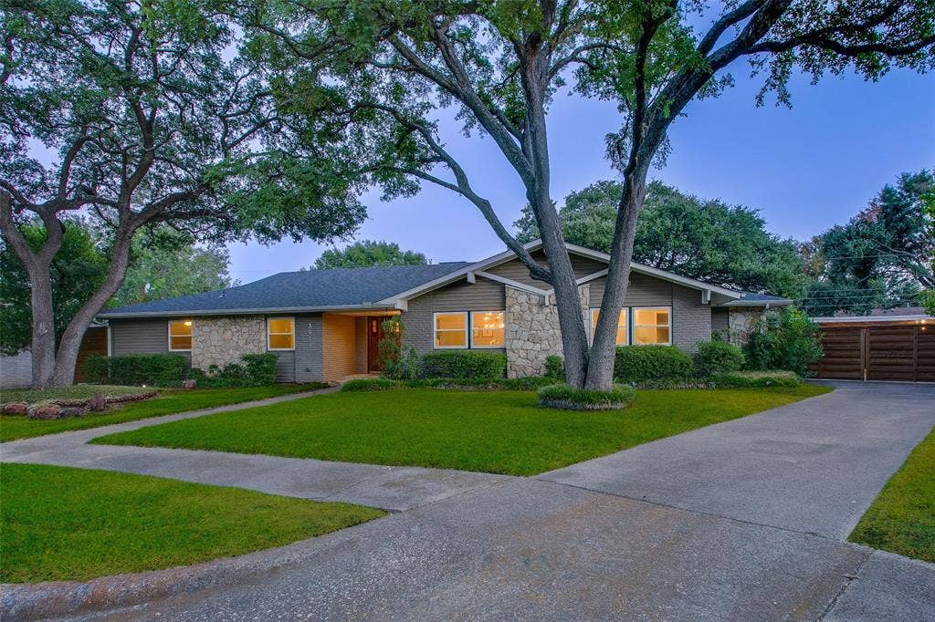 3918 Royal Palms Court, Dallas, TX 75244 Nearly one-third-acre setting with mature trees and a motorized gated driveway.