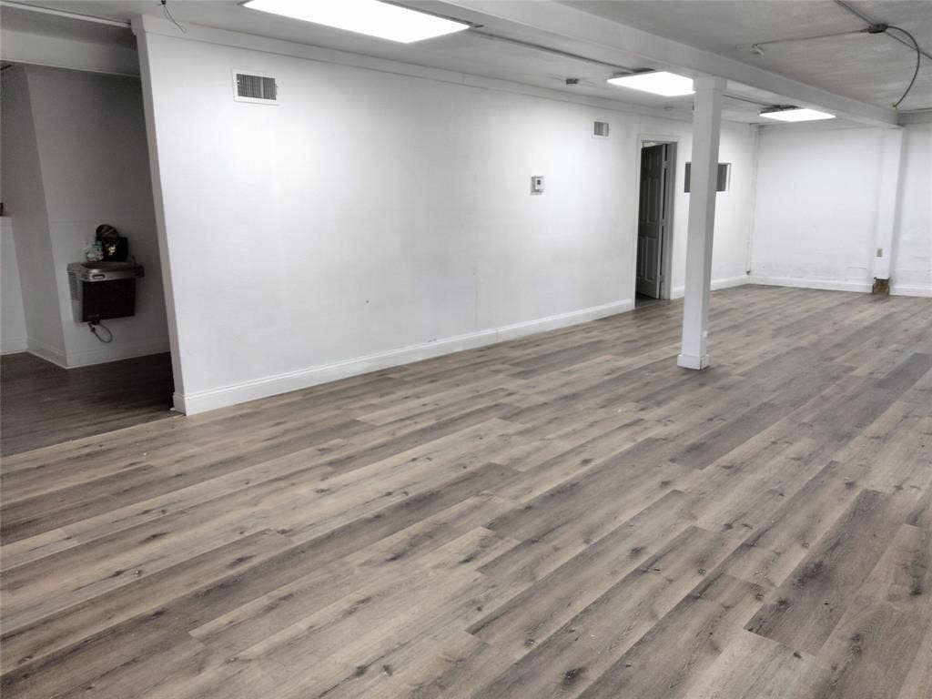 513 N 4th Street, Princeton, TX 75407 Expansive interior space featuring wood-finish flooring, white walls, and recessed lighting fixtures