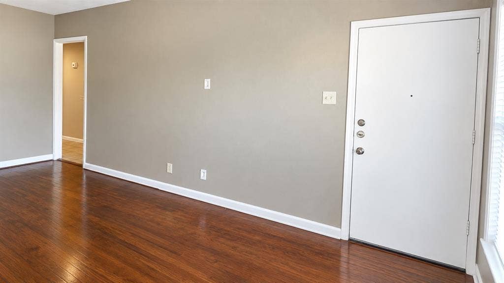 914 Harlandale Avenue, Dallas, TX 75216 Wood-finish flooring, neutral wall paint, white trim, and a white entrance door