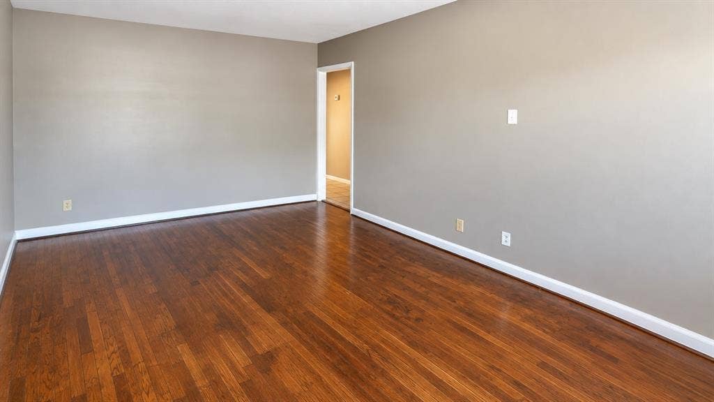 914 Harlandale Avenue, Dallas, TX 75216 Hardwood flooring, light gray walls, white trim, and a bright doorway