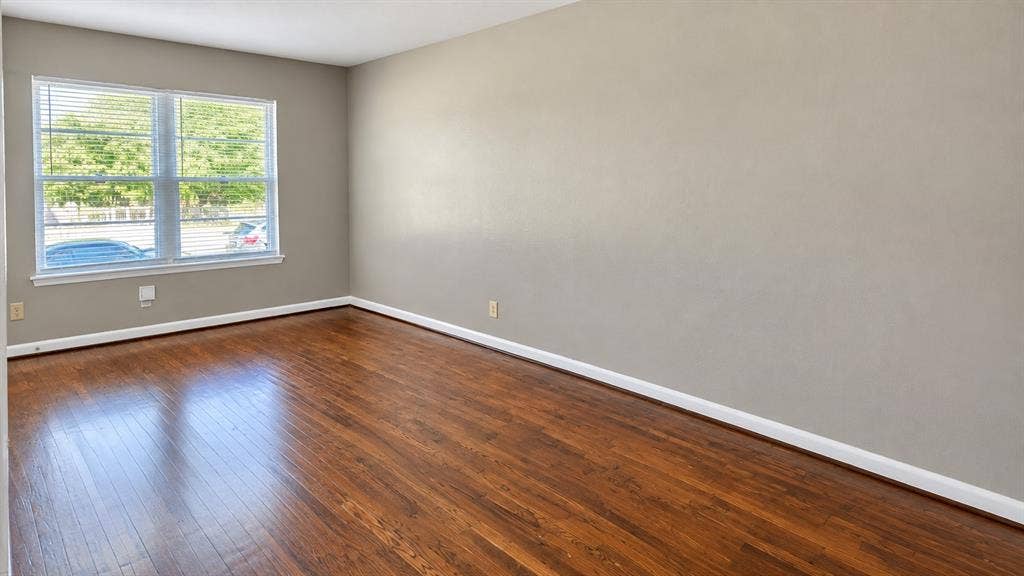 914 Harlandale Avenue, Dallas, TX 75216 Wood-finish flooring, neutral wall tones, and a window with horizontal blinds