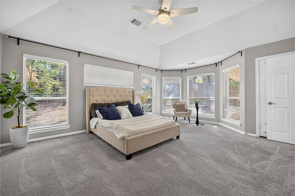 1102 Hartman Court, Arlington, TX 76006 Vaulted ceiling, multiple windows with blinds, gray carpet flooring, ceiling fan with light fixture, and white interior door