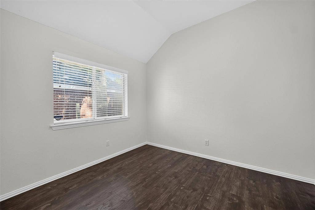 1102 Hartman Court, Arlington, TX 76006 Vaulted ceiling, white walls, wood-finish flooring, white window trim, and white baseboards
