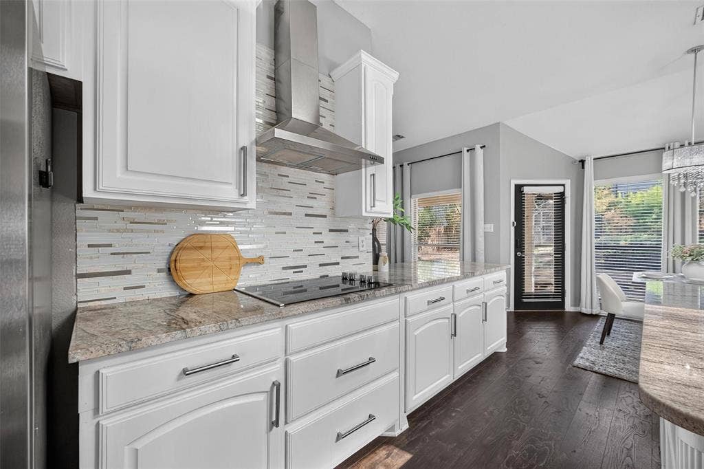 1102 Hartman Court, Arlington, TX 76006 White cabinetry with brushed nickel hardware, light-toned granite countertops, and a full tile backsplash